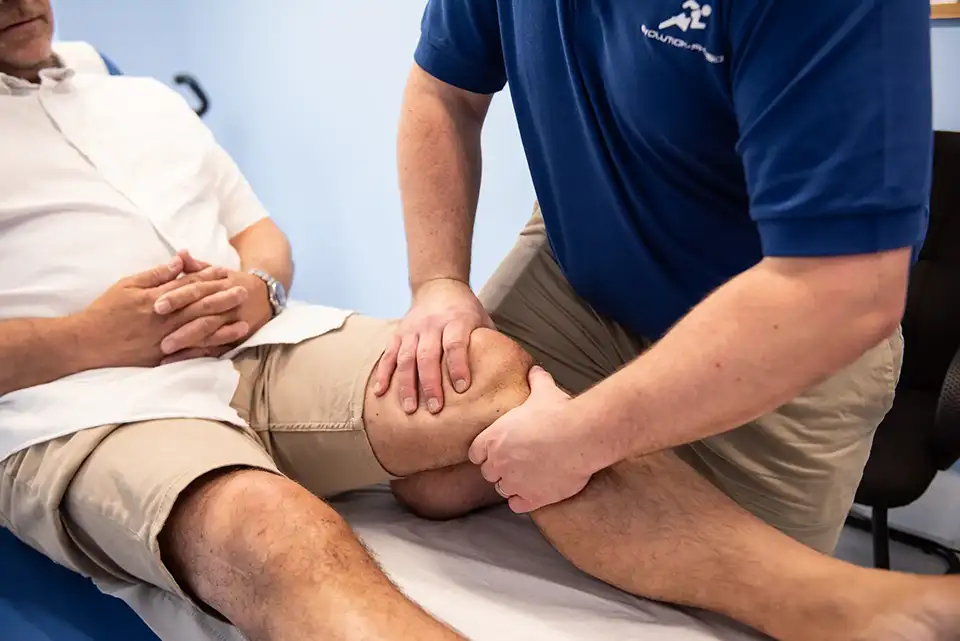 Man having his knee massaged